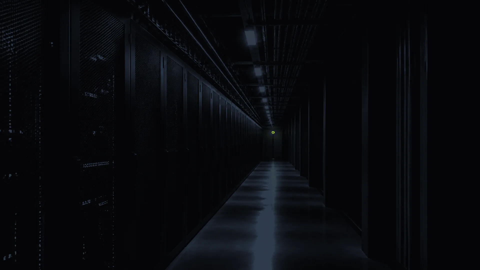 Dark infrastructure corridor with a single yellow signal light at the end.